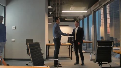 Business Handshake in Modern Office Building