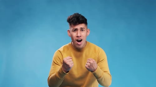 Expressive Young Man Clenching Fists and Shouting