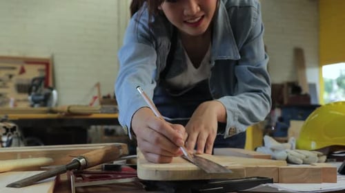 Woman Marking Wood with Pencil and Ruler