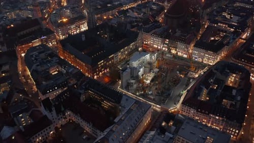 Huge Construction Building Site in Urban Environment City Center of Munich, Germany at Night with
