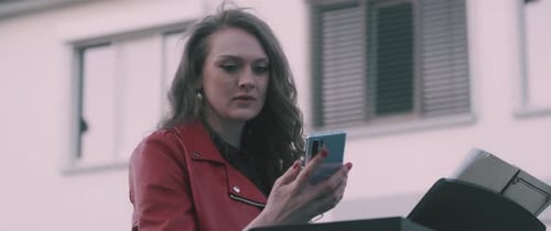 Young Woman Using Phone in Urban Setting