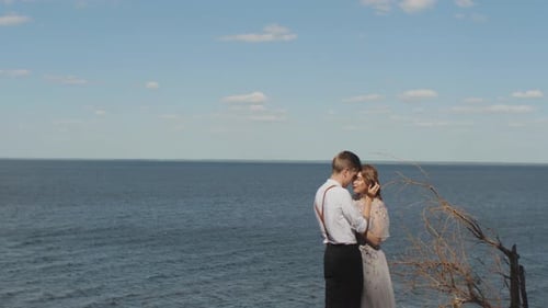 Couple in Love Hugs the Couple Stands Opposite Each Other with Their Eyes Closed the Sea is in the