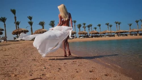 Young Fashion Woman Wearing Pareo Walking on the Beach