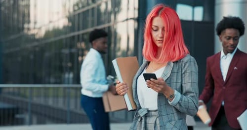 Office Secretary Assistant to Boss Walks Out of Company's Glass Building for Business Meeting Woman