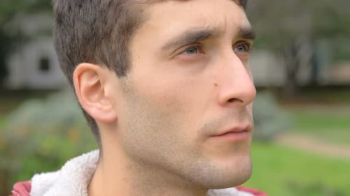 Success,hope.Attractive young man in the park, looking up the sky