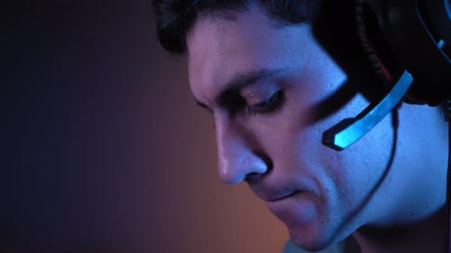 Intense Male Gamer Plays Video Games in the Dark