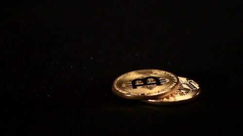 Bitcoins falling on a Black Surface