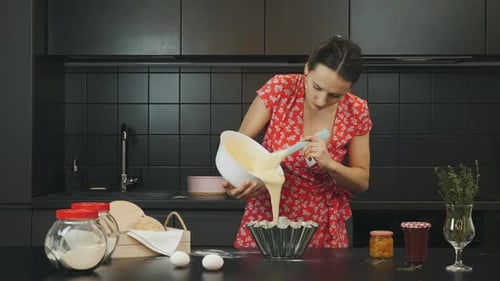 Woman Pours Cake Batter in Kitchen