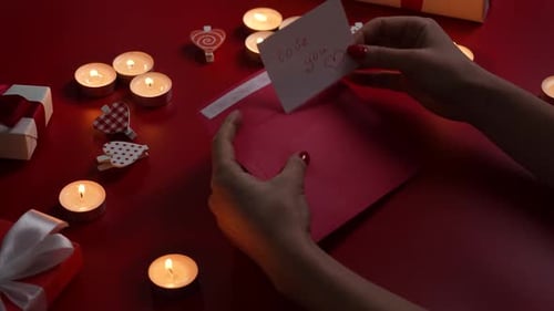 Romantic Hands Sealing Love Letter with Candles