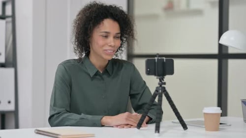 Woman on Video Call with Smartphone and Tripod