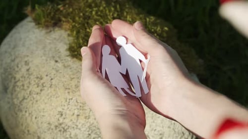 Woman Open Palms with Paper Origami As Family Image Inside