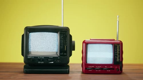 Hand Tuning Two Retro Style Television Sets