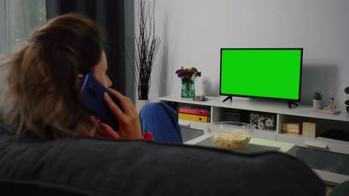 Woman Talking on Phone and watching Tv Green Screen.