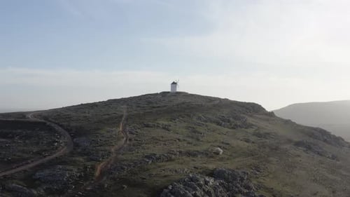 From above white windmill on field