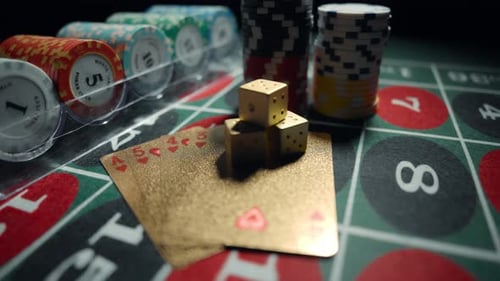Casino Chips with Dice and Playing Cards on a Dark Table