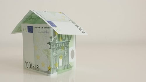 Hundred euro banknotes arranged like house on white 4K 2160p 30fps UltraHD tilting footage - Con