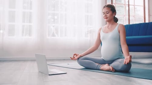 Pregnant Woman Practicing Yoga at Home