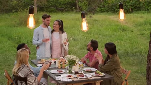 Friends Gather Outdoors for a Celebratory Toast