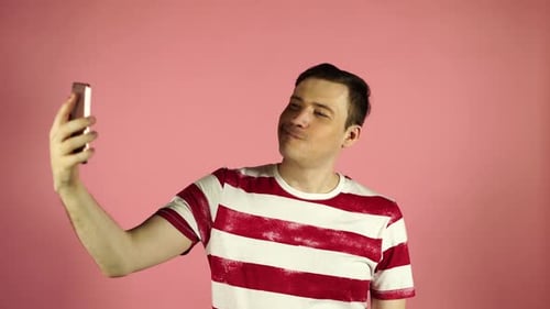 Man Taking Selfie on Mobile Phone in Studio