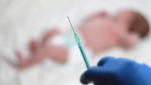 Syringe Held in Front of Baby in Hospital