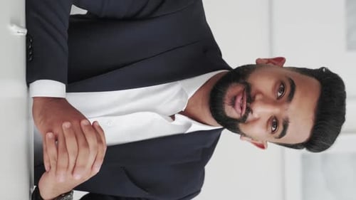 Professional Man Explains Financial Data on Tablet