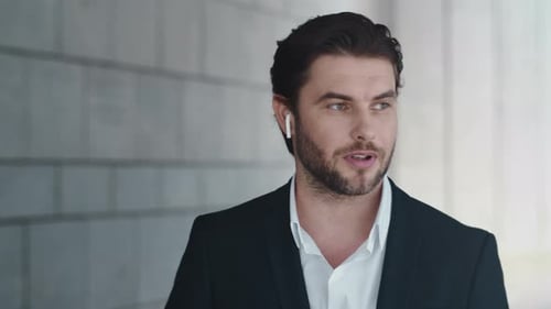 Businessman Using Earphones on Street. Entrepreneur Talking By Bluetooth Earbuds