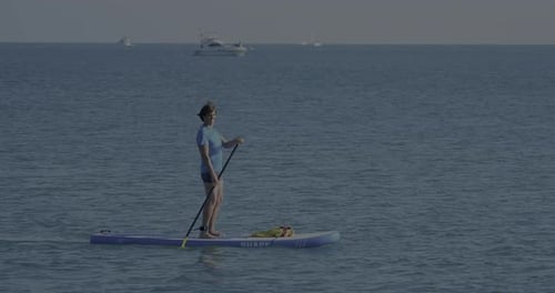Paddleboarding on Calm Blue Ocean Water on Sunny Day