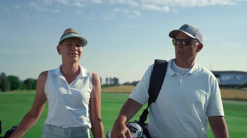 Couple Walking on the Golf Course on Sunny Day