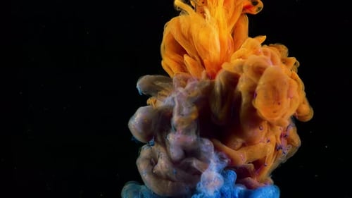 Abstract Blue and Orange Ink Dropping into Black