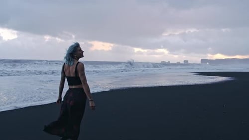 Blue Haired Cool Girl Walking Along Black Beach