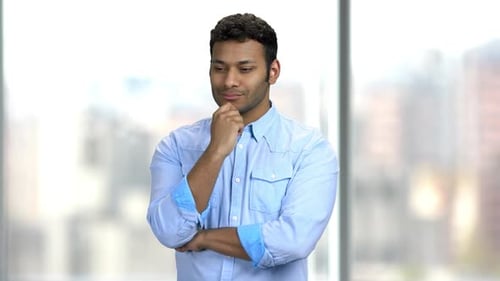 Man Thinking Deeply While Standing Near Window
