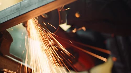Angle Grinder Cutting Metal at Workshop