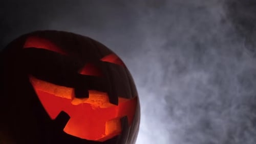 Eerie Jack-o'-lantern Glowing in Smoky Night