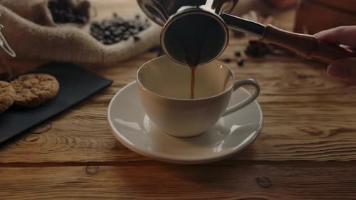 Coffee Pouring into a Cup with Cookies