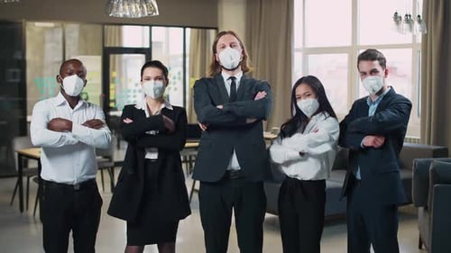 Office Team Stands and Looks at the Camera Managers in Protective Medical Masks Working in the