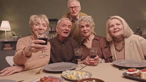 Adults Celebrating with Wine at Indoor Gathering