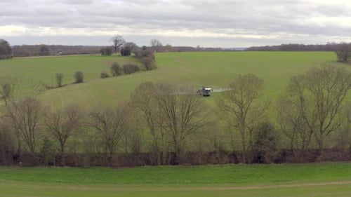 Tractor Spraying Wide Green Rural Field