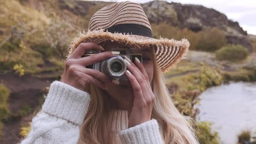 Blonde Woman Taking Photos in Nature With Camera