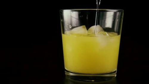 Refreshing Cold Drink with Ice Being Poured