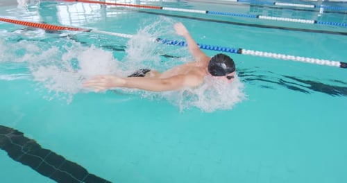 Swimmer swimming into the pool