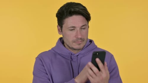 Man in Hoodie Using Smartphone, Close Up