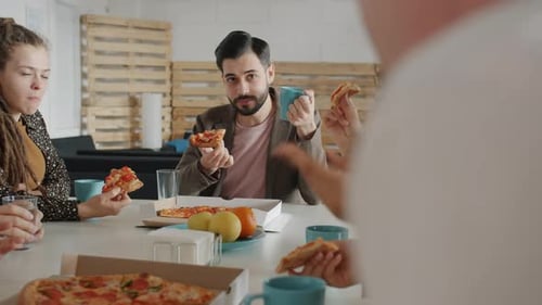 Group of People Colleagues Talking and Laughing Enjoying Tasty Pizza in Office