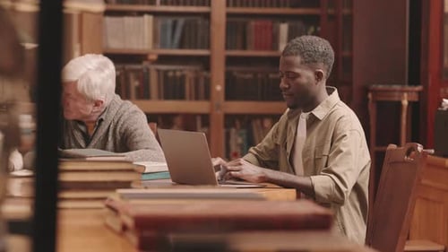 Student Studying on Laptop in Library