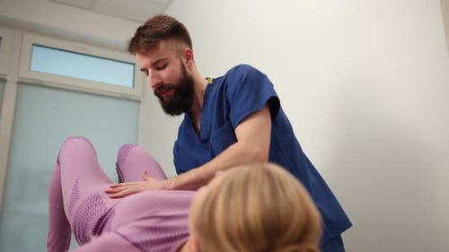 Medical Professional Examining Female Patient in Clinic