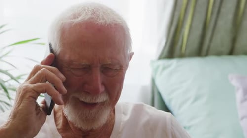 Smiling Senior Man Talking on Cell Phone at Home