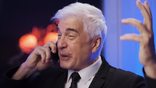 Man With White Hair Talking on Phone