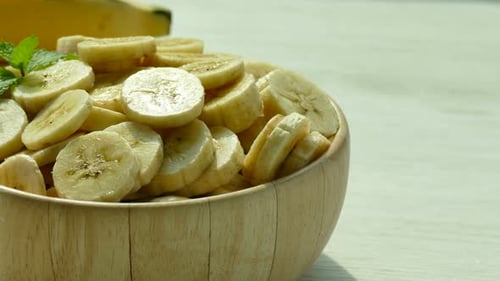 Close-up of Banana Slices in Wooden Bowl