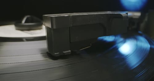 Turntable Needle on Rotating Vinyl Record Close Up