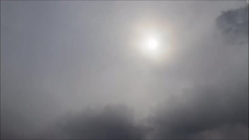 Time lapse: the sun shining through thik dense stormy snowing clouds. 4K