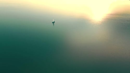 Aerial View One Yacht at Sunset in the Open Sea. Flight at Sunset Near the Yacht with a Sail View
